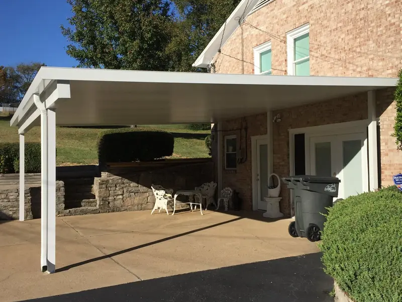 Attached aluminum carport on the side of a brick home