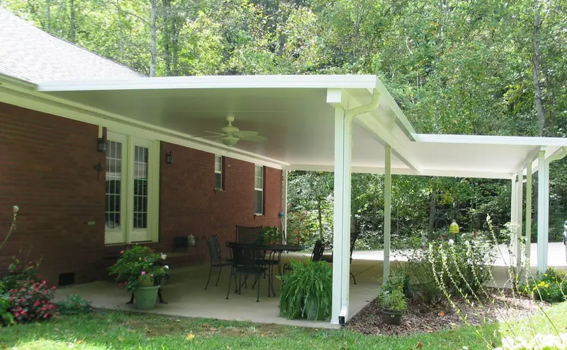 Wraparound patio cover over a concrete patio on a brick ranch home